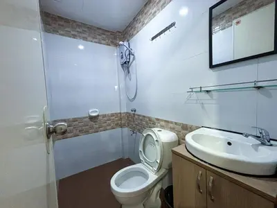 a bathroom with a toilet and a sink at The Budget Inn in Manila