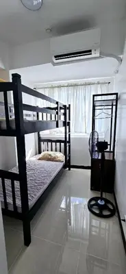 a bedroom with two bunk beds and a window at LA Nook in Manila