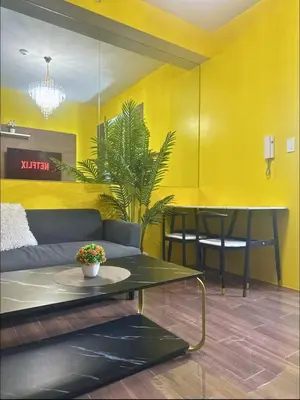 a living room with a couch and a table at Sunbeam - Air Residence 45th floor in Manila