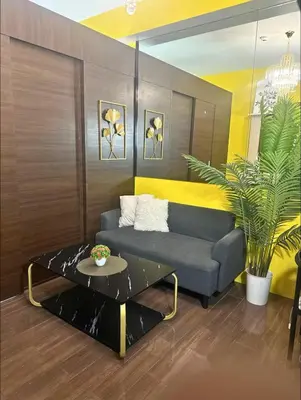 a living room with a couch and a table at Sunbeam - Air Residence 45th floor in Manila
