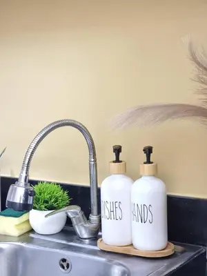 two bottles on a counter next to a sink at MP shore 1 c2 unit1583 in Manila