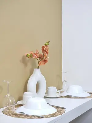 a white vase with flowers in it on a table at MP shore 1 c2 unit1583 in Manila