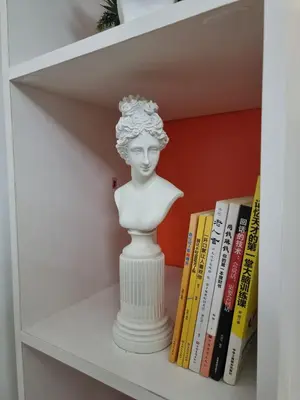 a bust of a woman on a shelf with books at MP shore 1 c2 unit1583 in Manila