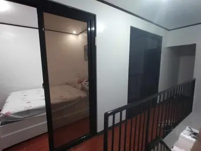 a mirror in a room with a bed and a bedroom at Affordable 2-Storys Whole house in Imus in Imus