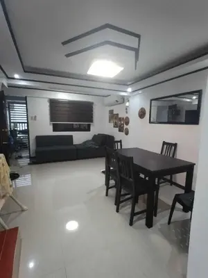 a dining room and living room with a table and chairs at Affordable 2-Storys Whole house in Imus in Imus