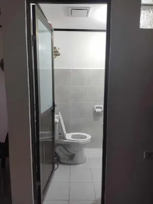 a bathroom with a toilet and a door open at Affordable 2-Storys Whole house in Imus in Imus