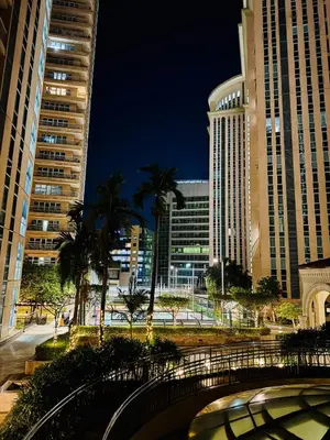 a bridge in a city with tall buildings at Cozy unit with balcony Netflix walk to Venice Mall in Manila