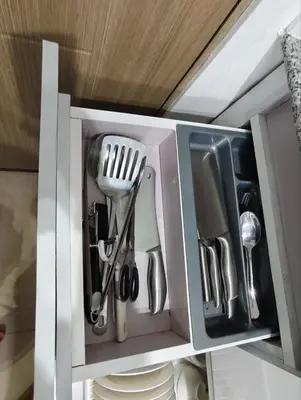 a cupboard with utensils in it at La Casa Victoria-Near Moa and NAIA in Manila