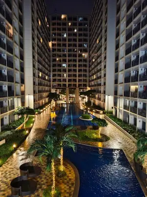 a large building with a pool in the middle of it at La Casa Victoria-Near Moa and NAIA in Manila