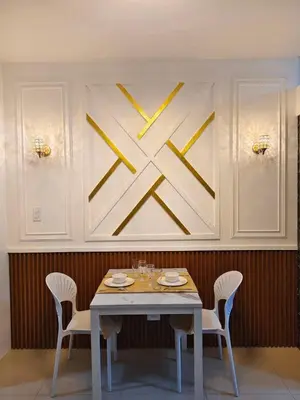 a table with chairs and a clock on the wall at La Casa Victoria-Near Moa and NAIA in Manila