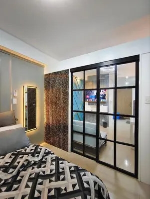a bedroom with a bed and a large window at La Casa Victoria-Near Moa and NAIA in Manila
