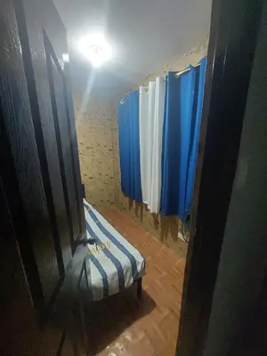 a bathroom with blue curtains and a bench in a room at Affordable Townhouse Imus cavite greenpark villas 2 in Imus