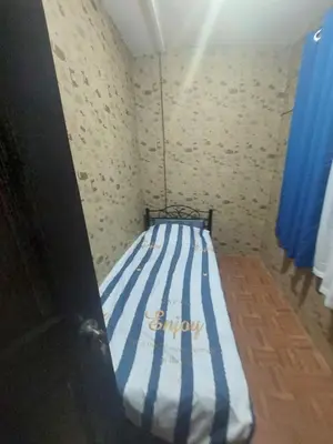 a bedroom with a bed with a blue and white striped mattress at Affordable Townhouse Imus cavite greenpark villas 2 in Imus