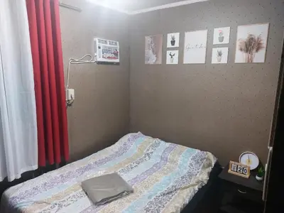 a bedroom with a bed and a red curtain at Affordable Townhouse Imus cavite greenpark villas 2 in Imus