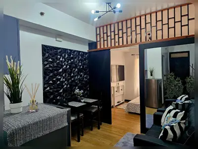 a living room with a table and a dining room at Paseo Verde Condo Unit in Las Pinas - Sleeps 2 Adults & 2 Children in Manila