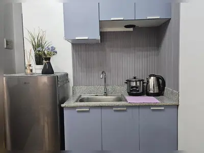 a kitchen with a sink and a stainless steel refrigerator at Paseo Verde Condo Unit in Las Pinas - Sleeps 2 Adults & 2 Children in Manila