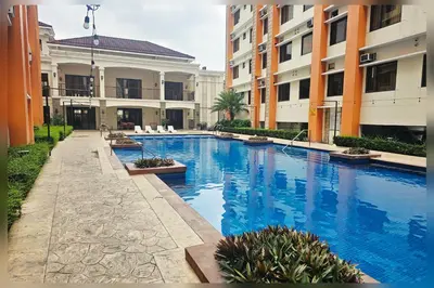 a swimming pool in the middle of a building at Paseo Verde Condo Unit in Las Pinas - Sleeps 2 Adults & 2 Children in Manila
