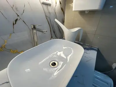 a bathroom with a white sink and a toilet at Casa Navarro - Estrella in Manila