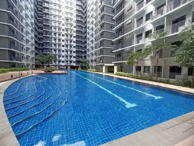 an empty swimming pool in front of some apartment buildings at Casa Navarro - Estrella in Manila