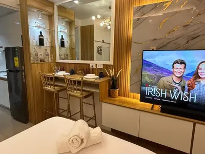 a room with a tv and a bar at Casa Navarro - Estrella in Manila