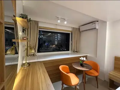 a living room with a table and chairs and a window at Casa Navarro - Estrella in Manila