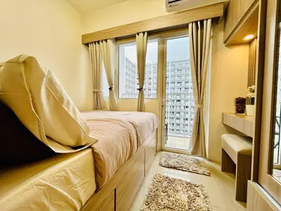a bedroom with a bed and a large window at Affordable Condotel Stay in Pasay, MOA Complex in Sampong