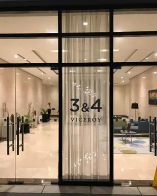a store front with a sign on the glass door at Cozy Studio Viceroy Residences in Manila