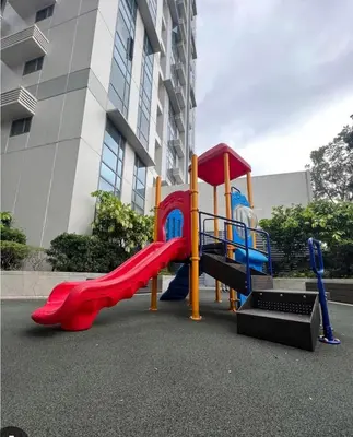 a playground with a slide in front of a building at Cozy Studio Viceroy Residences in Manila