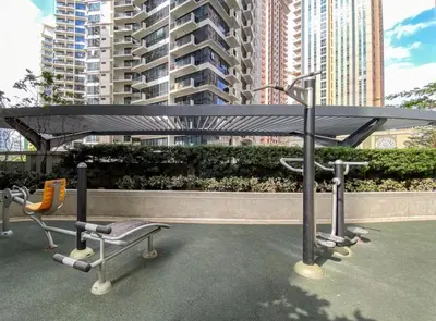 a bench and a table in a city with buildings at Cozy Studio Viceroy Residences in Manila