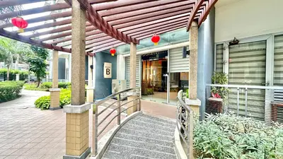 an entrance to a building with a wooden pergola at One Palm Tree Villas at Newport, Near NAIA T3 in Manila