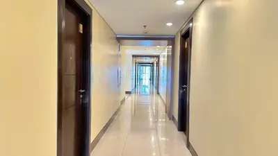 a hallway with a long corridor with white walls at One Palm Tree Villas at Newport, Near NAIA T3 in Manila