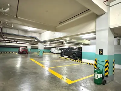 an empty parking garage with cars parked in it at One Palm Tree Villas at Newport, Near NAIA T3 in Manila