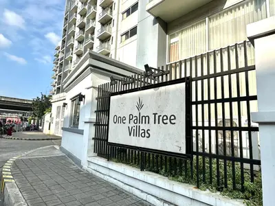 a sign on a fence in front of a building at One Palm Tree Villas at Newport, Near NAIA T3 in Manila