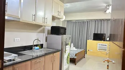 a small kitchen with a sink and a refrigerator at One Palm Tree Villas at Newport, Near NAIA T3 in Manila