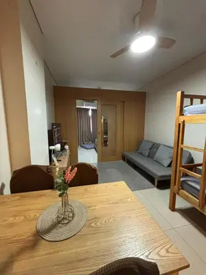 a living room with a table and a couch at Lundayan Staycation in Manila