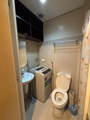 a small bathroom with a toilet and a sink at Lundayan Staycation in Manila
