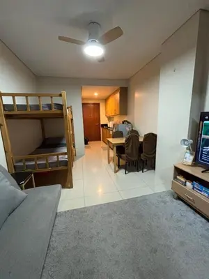 a living room with a bunk bed and a dining room at Lundayan Staycation in Manila