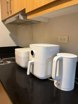 two white appliances sitting on a counter in a kitchen at Lundayan Staycation in Manila