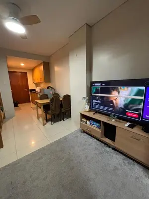 a living room with a large flat screen tv at Lundayan Staycation in Manila