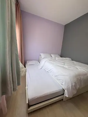 a small bedroom with a bed with white sheets at Jopays 2BR, Brand New Unit in Cainta