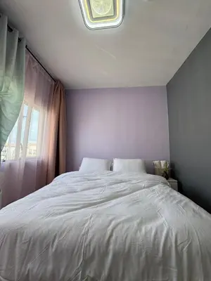 a bedroom with a white bed with a window at Jopays 2BR, Brand New Unit in Cainta