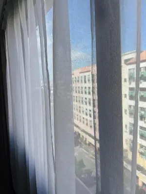 a window with a view of a building at Jopays 2BR, Brand New Unit in Cainta