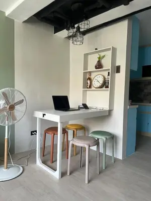 a room with a desk with a laptop and stools at Jopays 2BR, Brand New Unit in Cainta