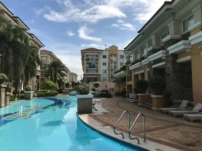 a swimming pool in the middle of a building at Cozy 2BR at an Italian inspired condo near Ortigas in Manila