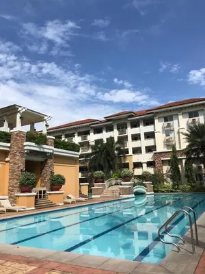 a swimming pool in front of a building at Cozy 2BR at an Italian inspired condo near Ortigas in Manila