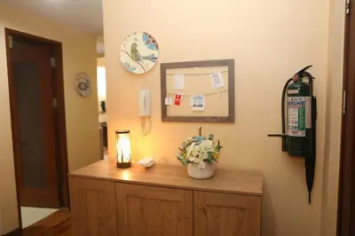 a room with a counter with a lamp and flowers on it at The Mosaic Tower in Manila