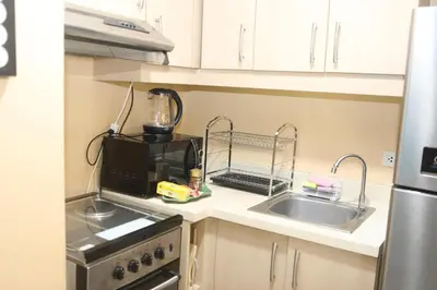a kitchen with a sink and a blender on a counter at The Mosaic Tower in Manila