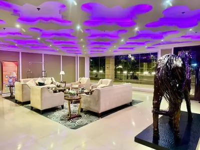 a living room with purple lights on the ceiling at Condo near MOA Monarch in Manila