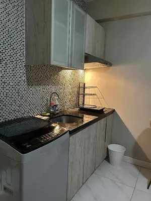 a kitchen with a sink and a dishwasher at Condo near MOA Monarch in Manila