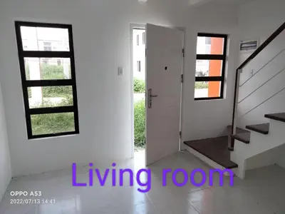 a living room with a staircase and a stair case at One Cenon place in Postema